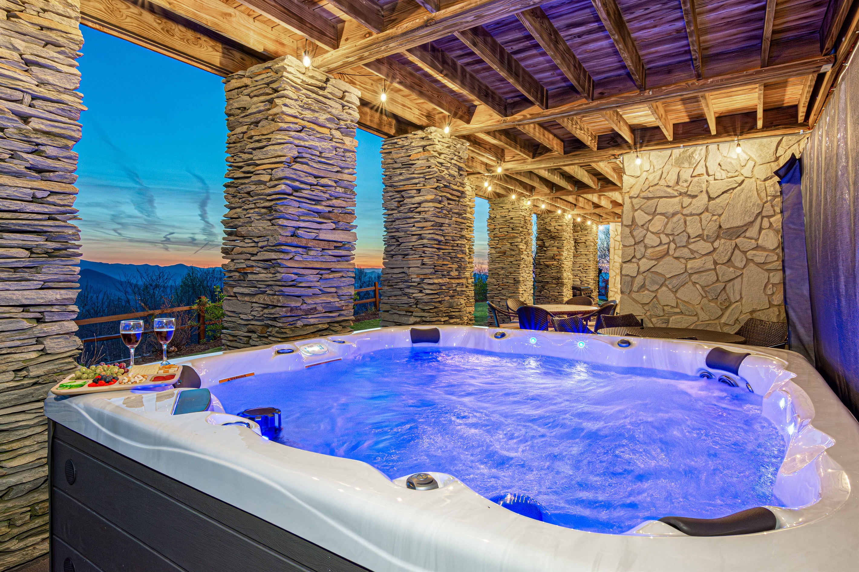 Hot tub: Unwind in the bubbling hot tub with stunning mountain views and twinkling lights!