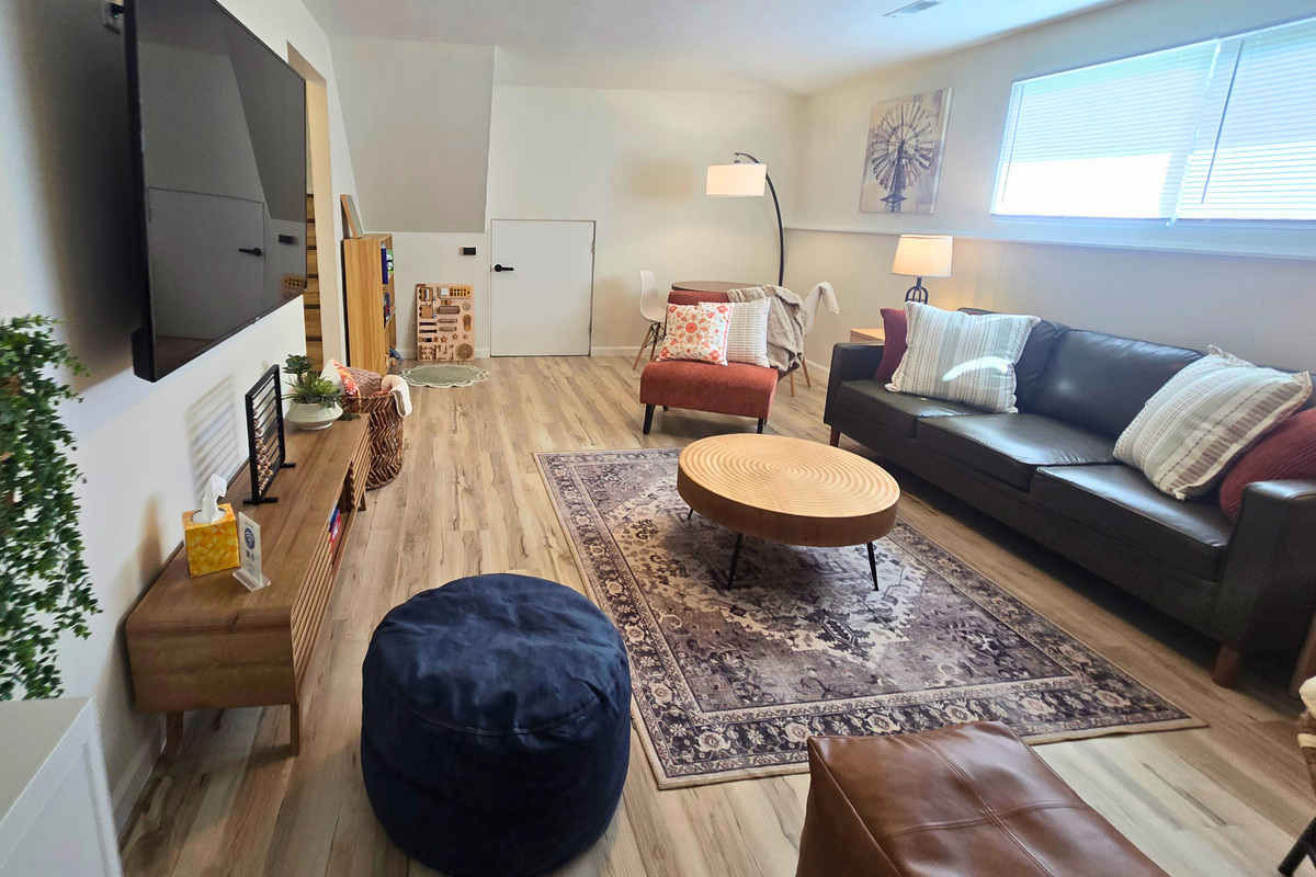Bright family room with Smart TV and comfortable seating for everyone.