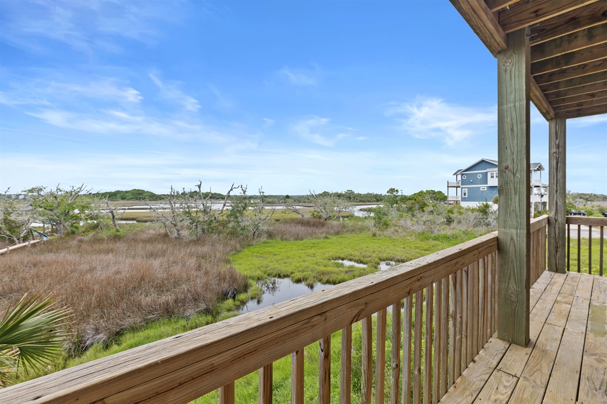 Peaceful marshfront balcony with wide open views and coastal serenity