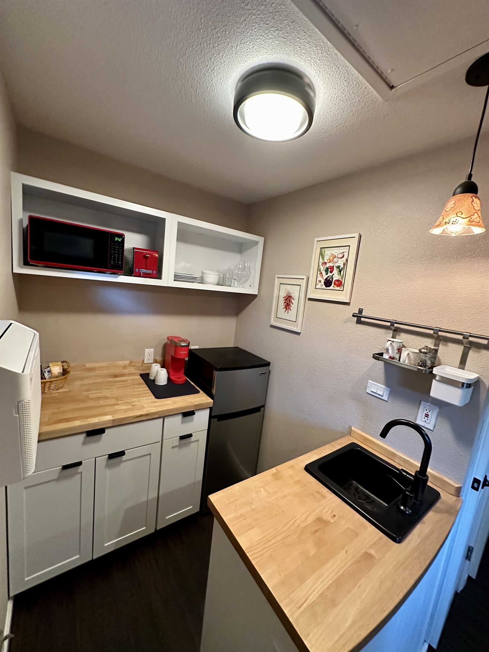 Peaceful bedroom corner w/ soft bedding & a warm glow
