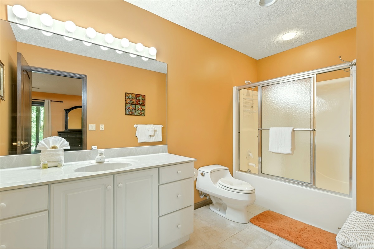 Lower level master bedroom en-suite bathroom with a bathtub/shower combo
