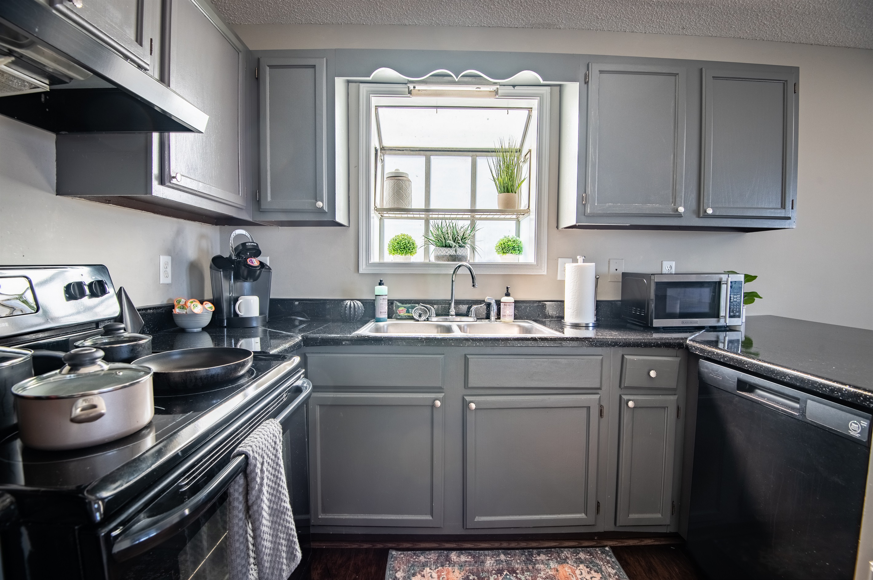 Unit B's full kitchen has plenty of natural lighting to enjoy slow mornings while sipping your coffee!