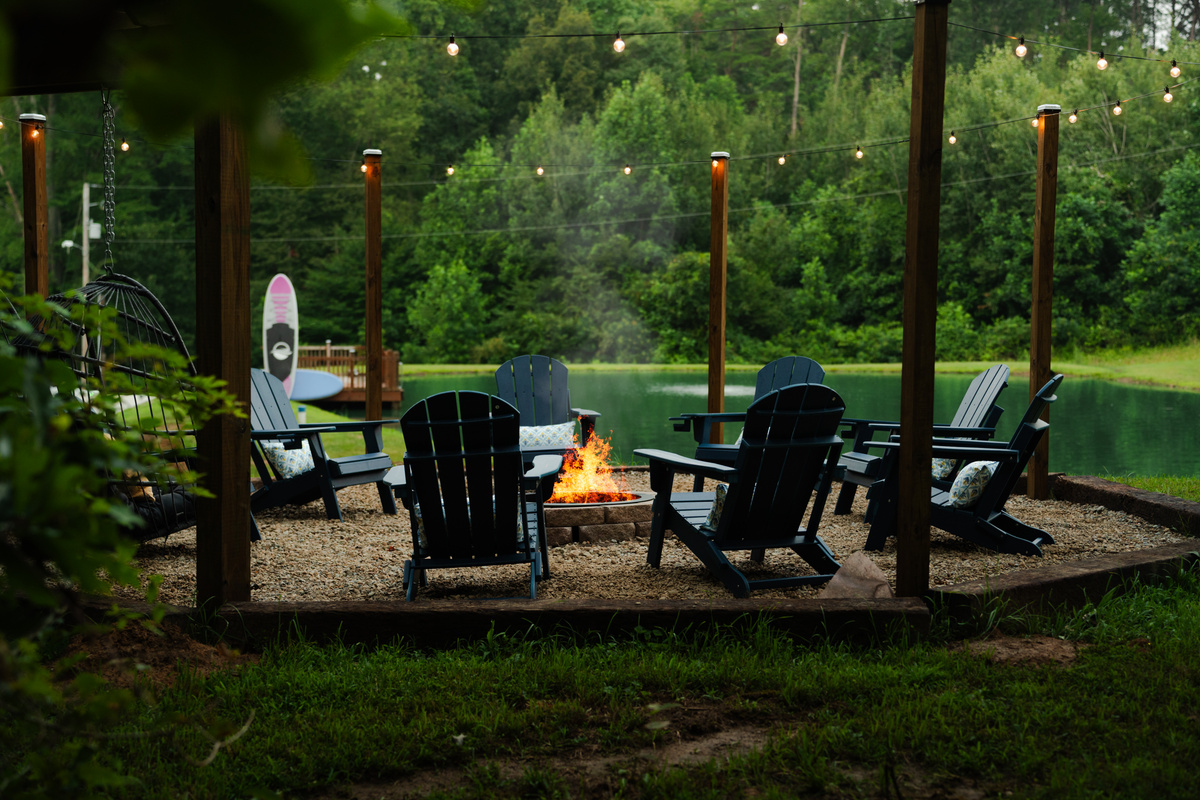 Gather around the firepit and enjoy peaceful views overlooking the pond and surrounding woods.