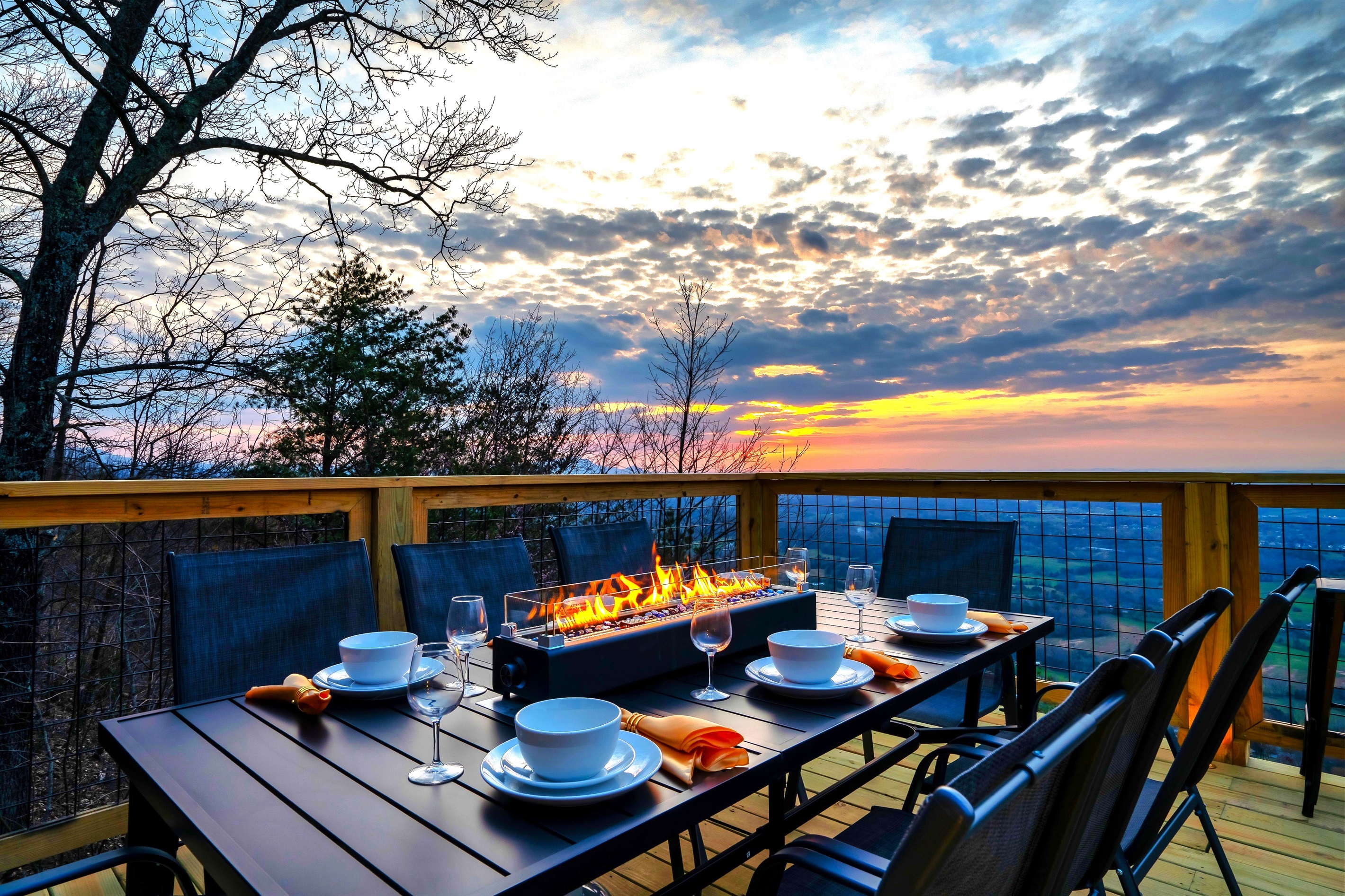 Enjoy a one-of-a-kind dinner by the fire with panoramic mountain views + city lights and a glowing sunset as your wallpaper.