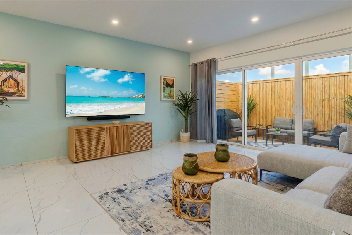 Bright, Stylish Living Room with Large Smart TV & Plush Sectional Sofa