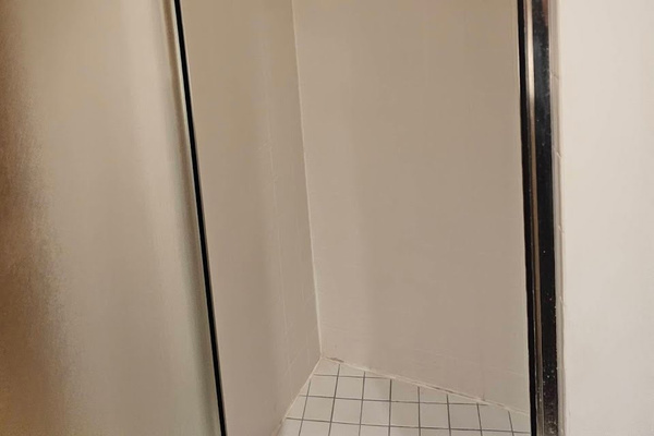 Bathroom with 2 sinks, shower, and toilet