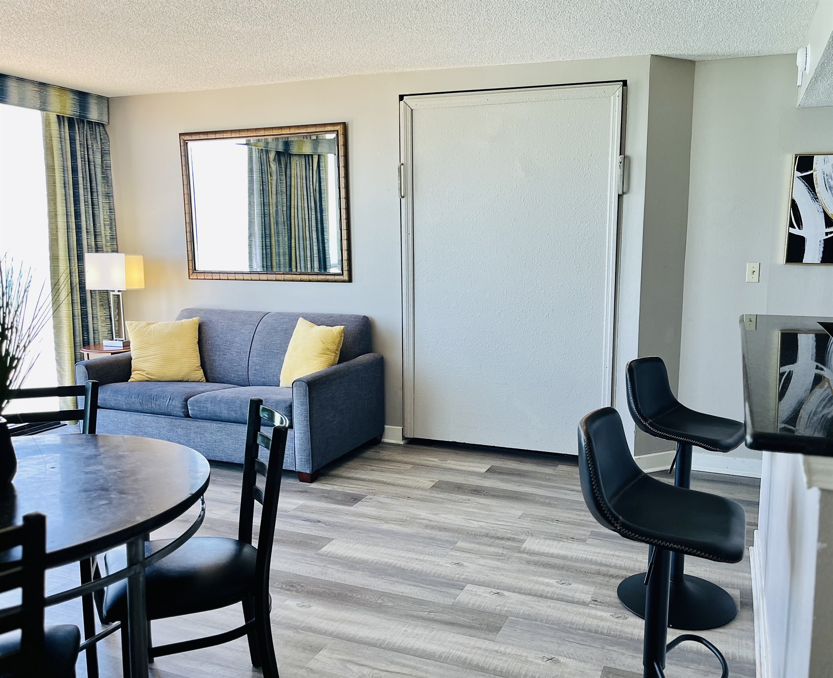 Experience open-air comfort in the living area, where the sliding glass doors bring in the coastal breeze, creating a refreshing and inviting space.