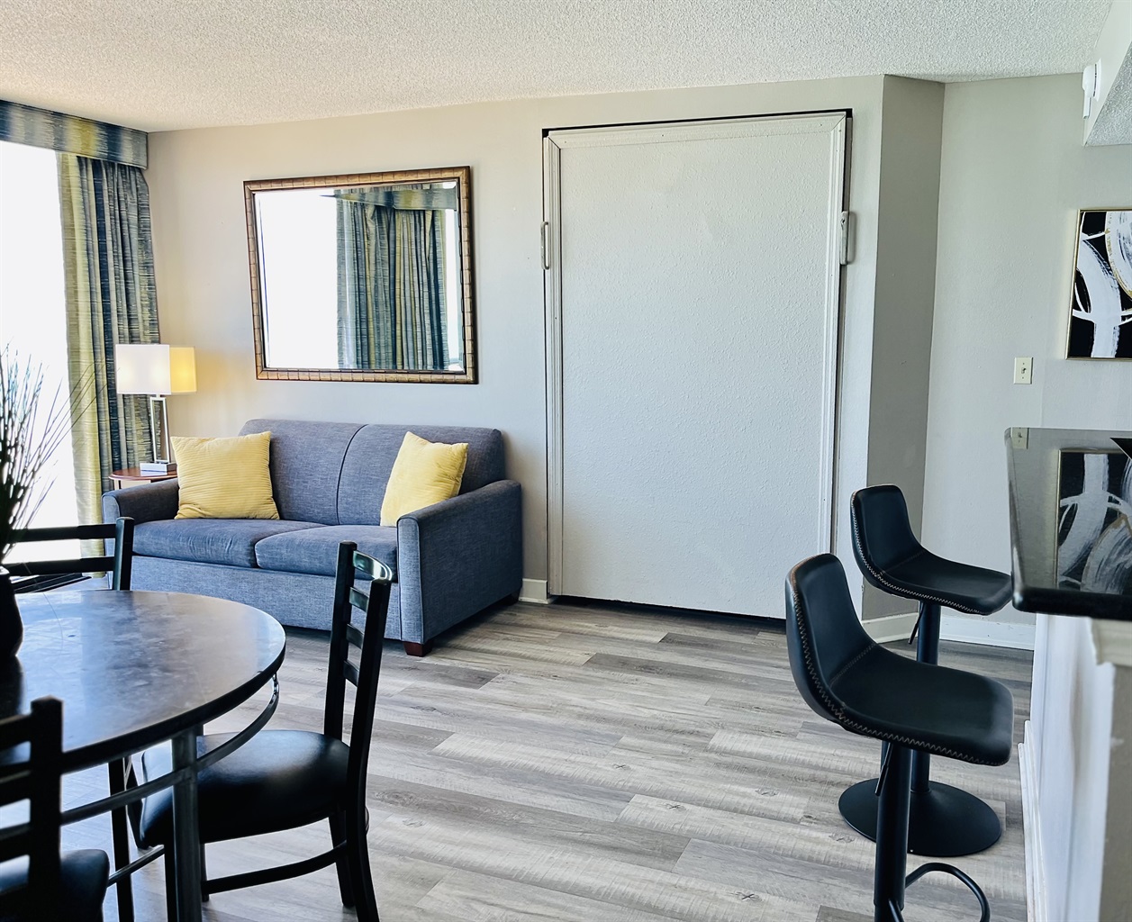 Experience open-air comfort in the living area, where the sliding glass doors bring in the coastal breeze, creating a refreshing and inviting space.