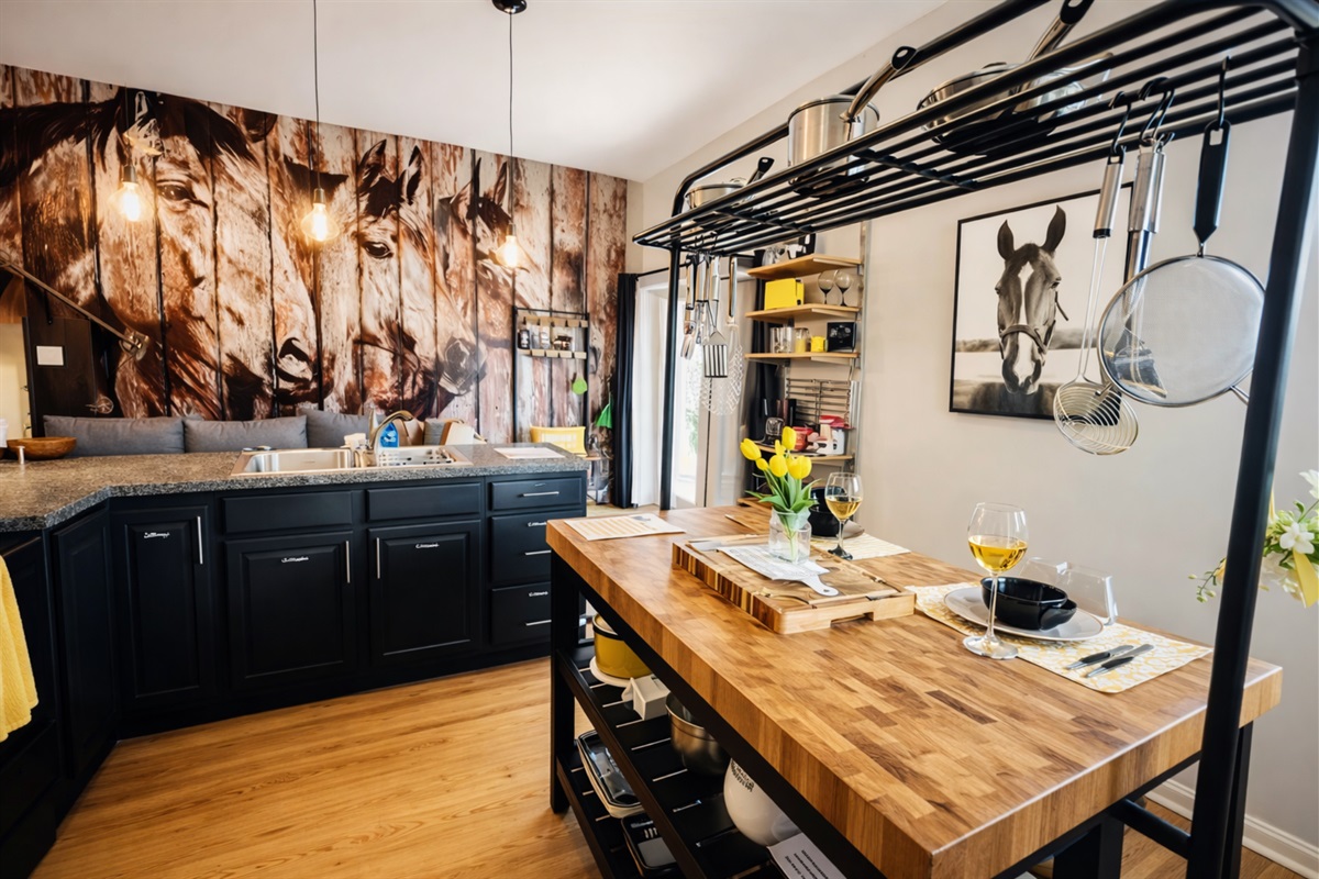 The kitchen is bright and fully equipped, offering delightful views of farm animals through every window