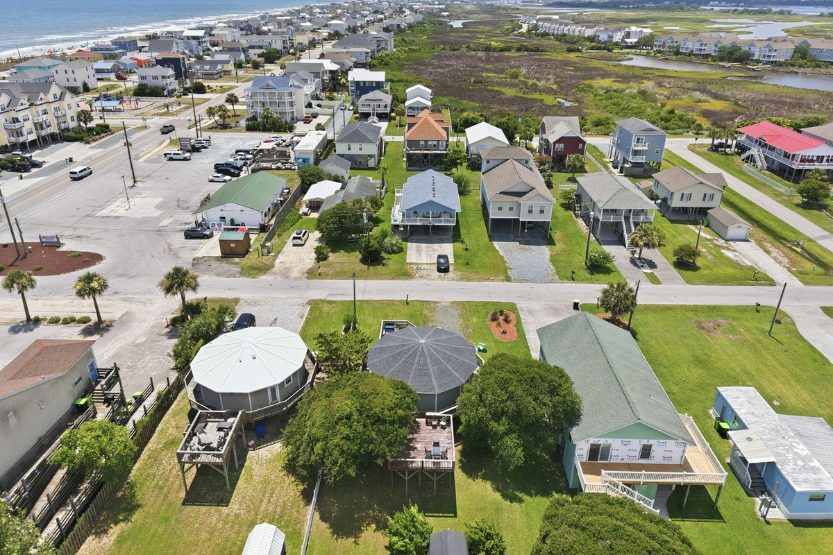 Aerial view of the surrounding neighborhood with easy access to the beach, shops, dining, and coastal attractions