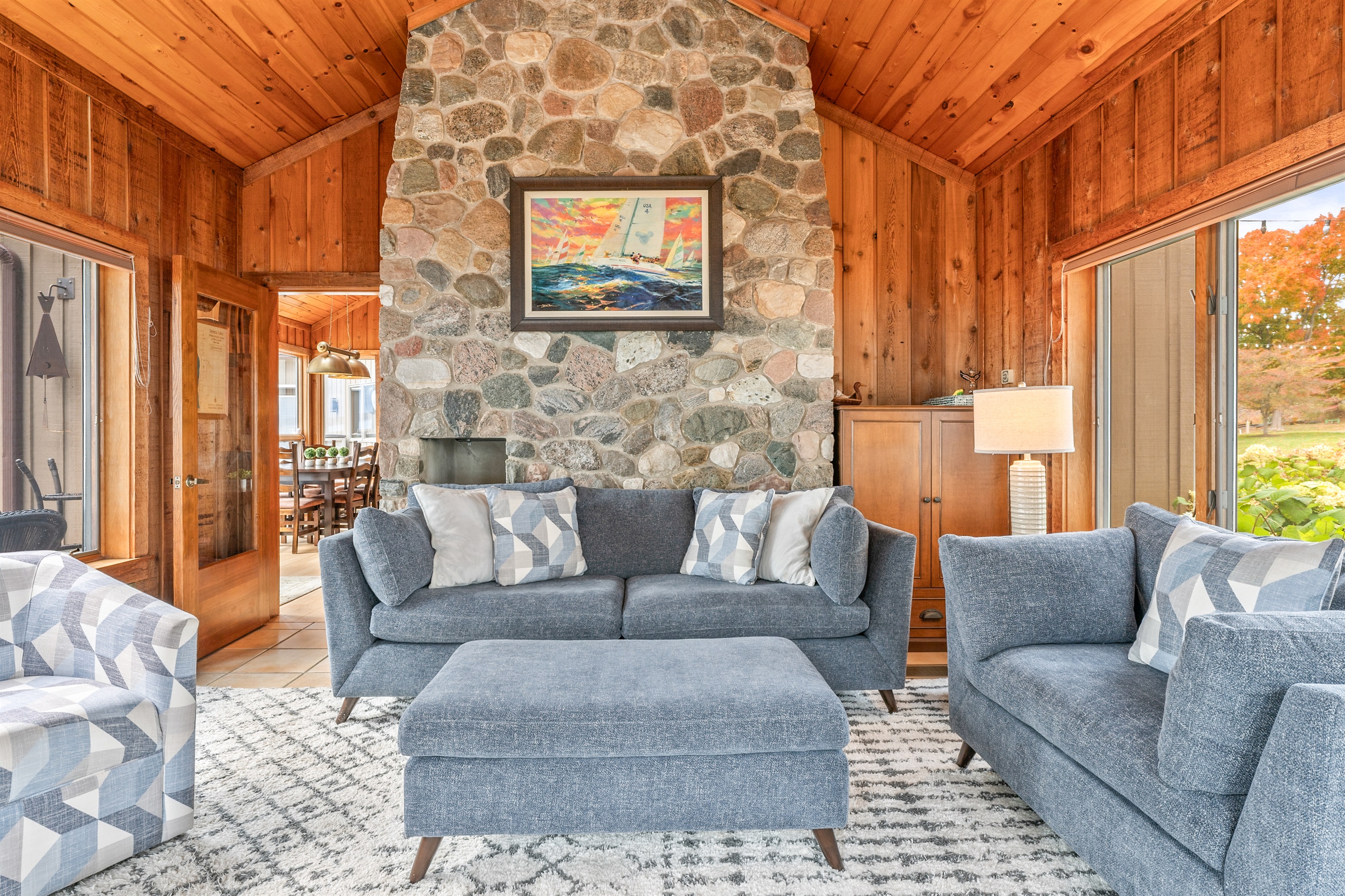 Rustic elegance and cozy comfort combine in this lake-view sitting area with a beautiful stone hearth and plush seating