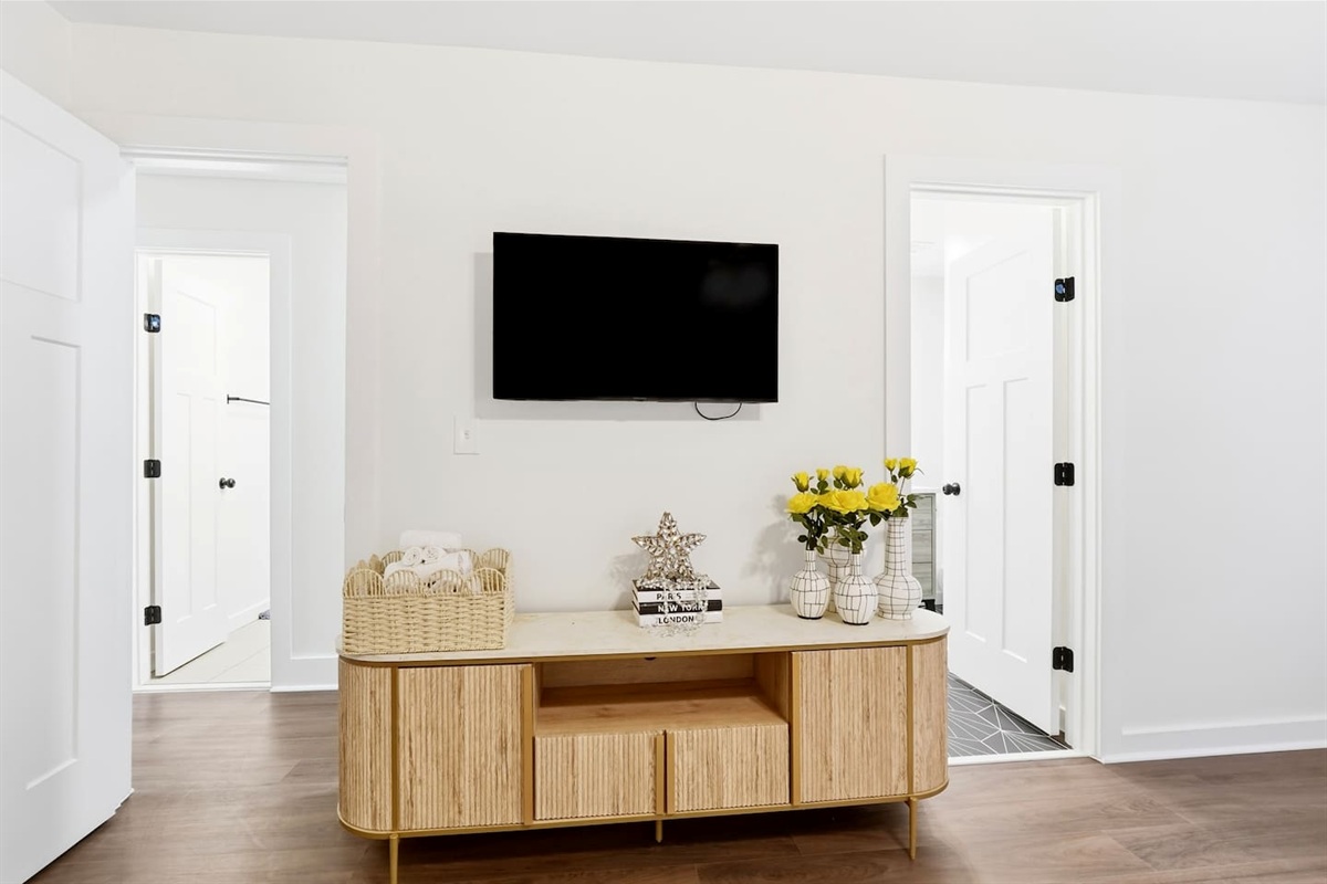 Cozy second-level bedroom featuring a king bed, a Roku-powered Smart TV, and located at the end of the hallway to the left at the top of the staircase. This room includes 2 full-body towels, 2 washcloths, and 2 hand towels for your stay.