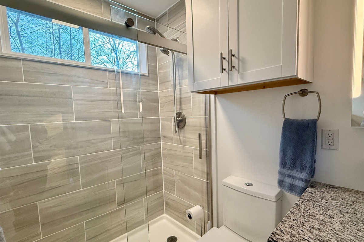 Start or end your day in the spacious tiled walk-in shower. Clean lines, bright finishes, and plenty of room to refresh after hiking, exploring, or simply relaxing at the cabin.