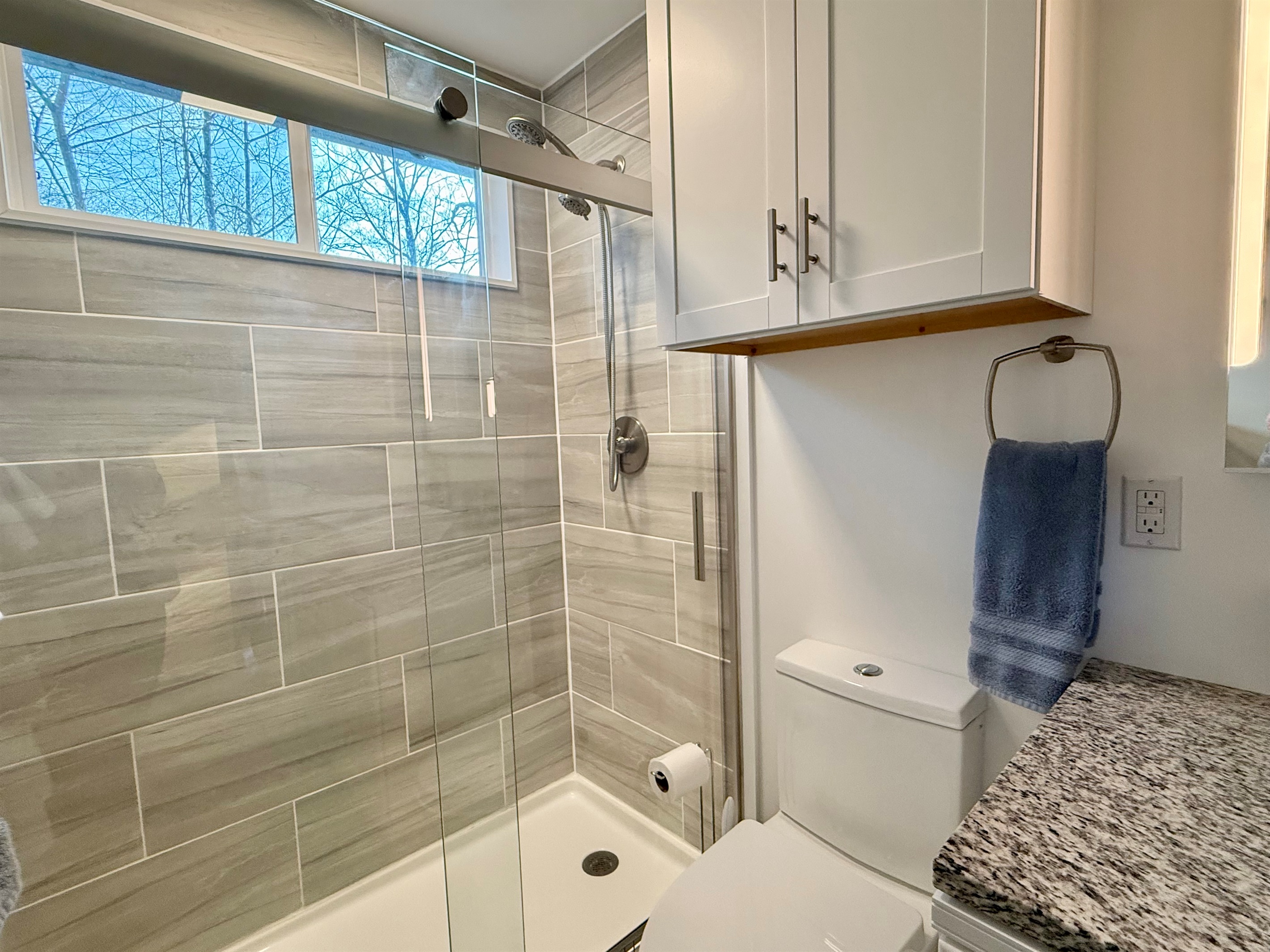 Start or end your day in the spacious tiled walk-in shower. Clean lines, bright finishes, and plenty of room to refresh after hiking, exploring, or simply relaxing at the cabin.