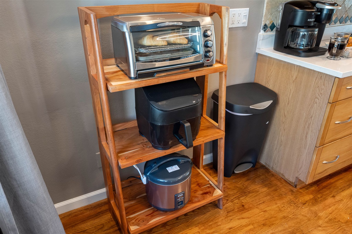 Equipped with a stainless steel oven, microwave, and French-door refrigerator, this kitchen is designed to meet every cooking need.