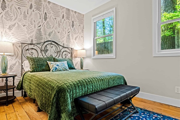 The guest bedroom with queen bed is inspired by a vintage botanical theme.