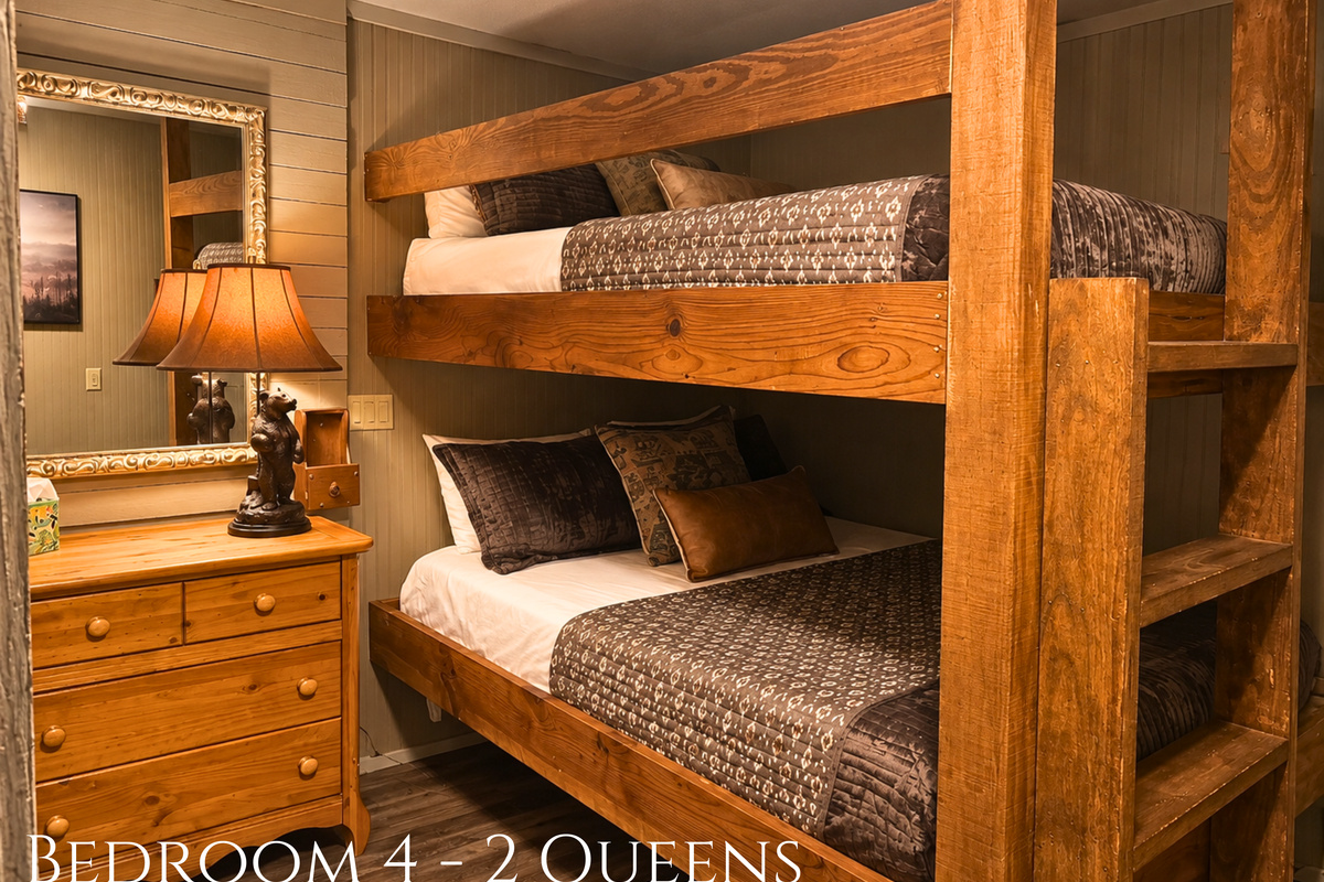 Built-in queen bunks bring a fun cabin feel to this sleeping space while offering a comfortable setup for kids, teens, or additional guests.