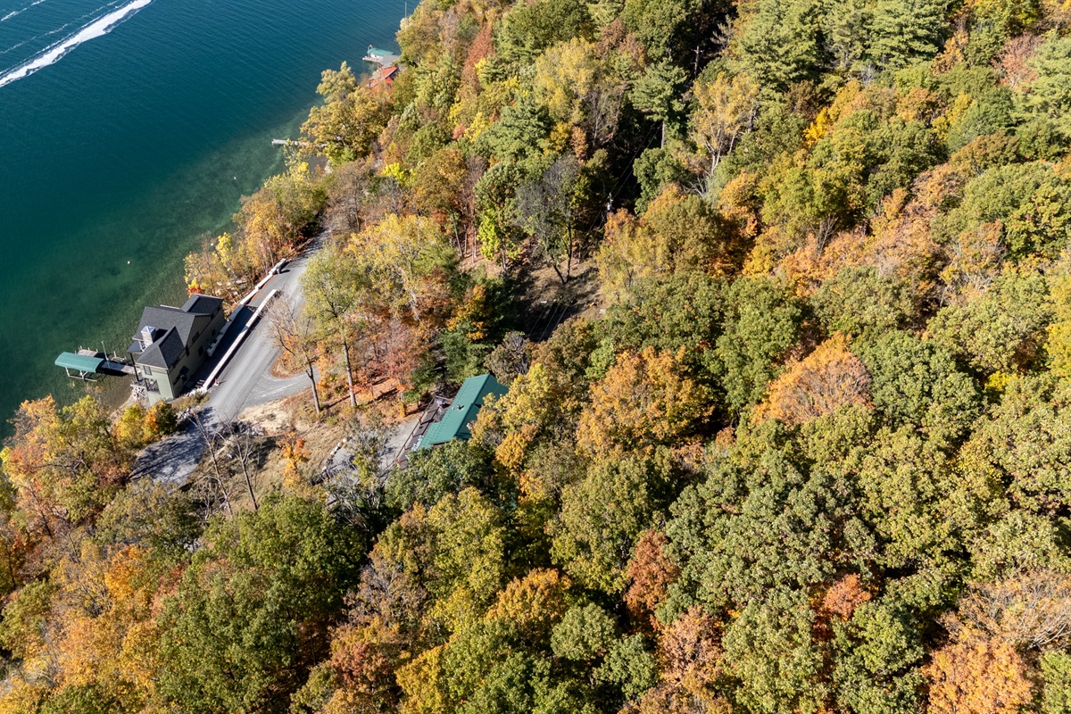 High-view of the property with the lake visible beyond — tranquility found here.