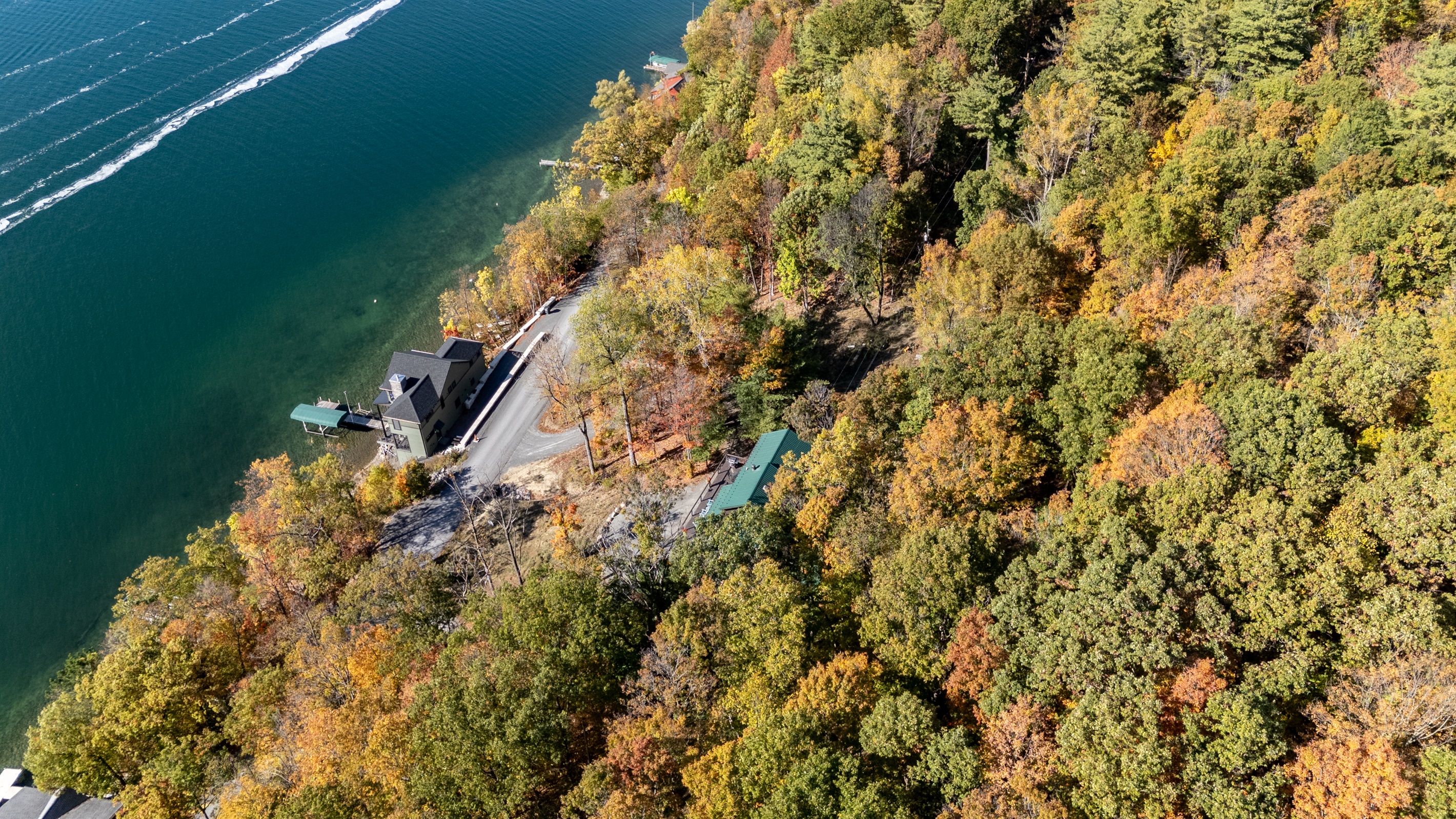 High-view of the property with the lake visible beyond — tranquility found here.