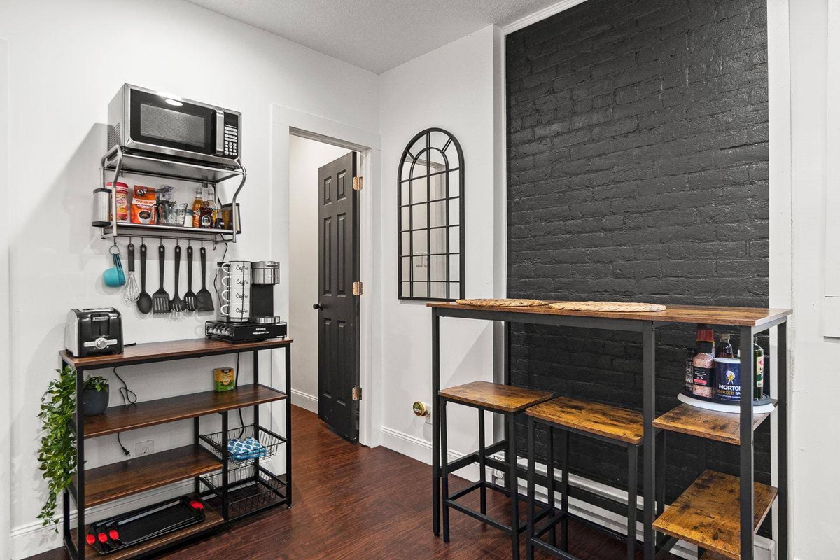 Bright and welcoming dining nook featuring stylish bench seating and a unique mirror accent. A cozy spot to enjoy meals or relax with a cup of coffee!