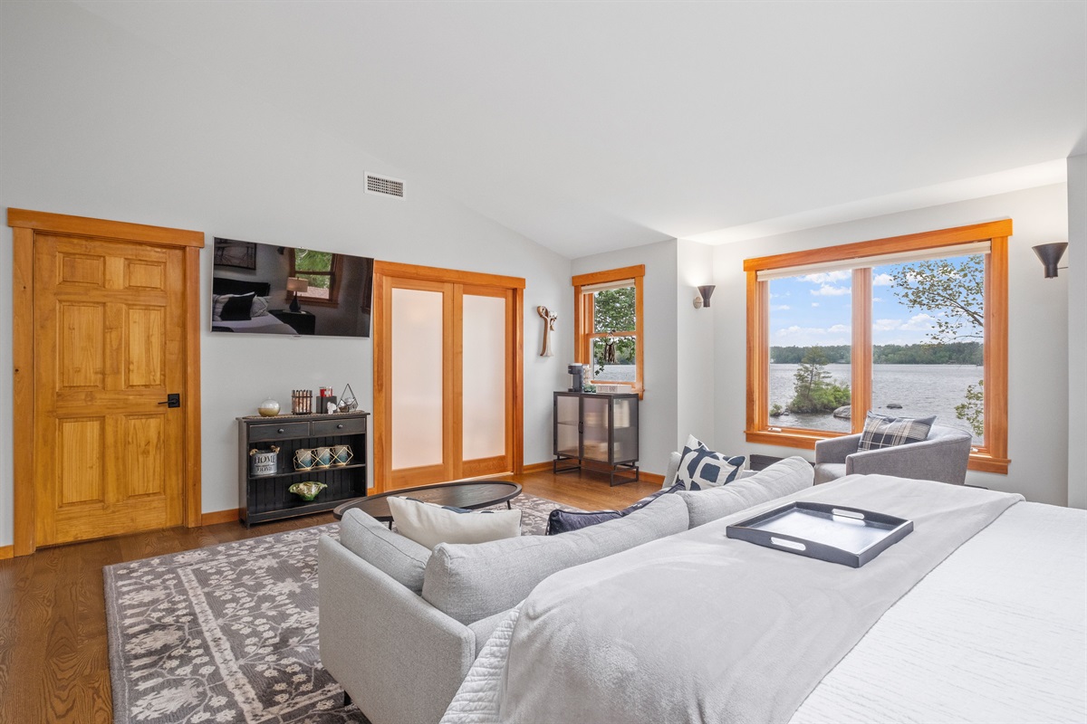Second floor master bedroom ensuite with king bed and couch and its own bathroom