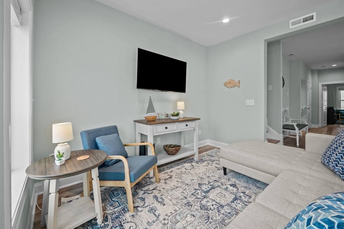 Living room with sectional, chair, and 55" TV