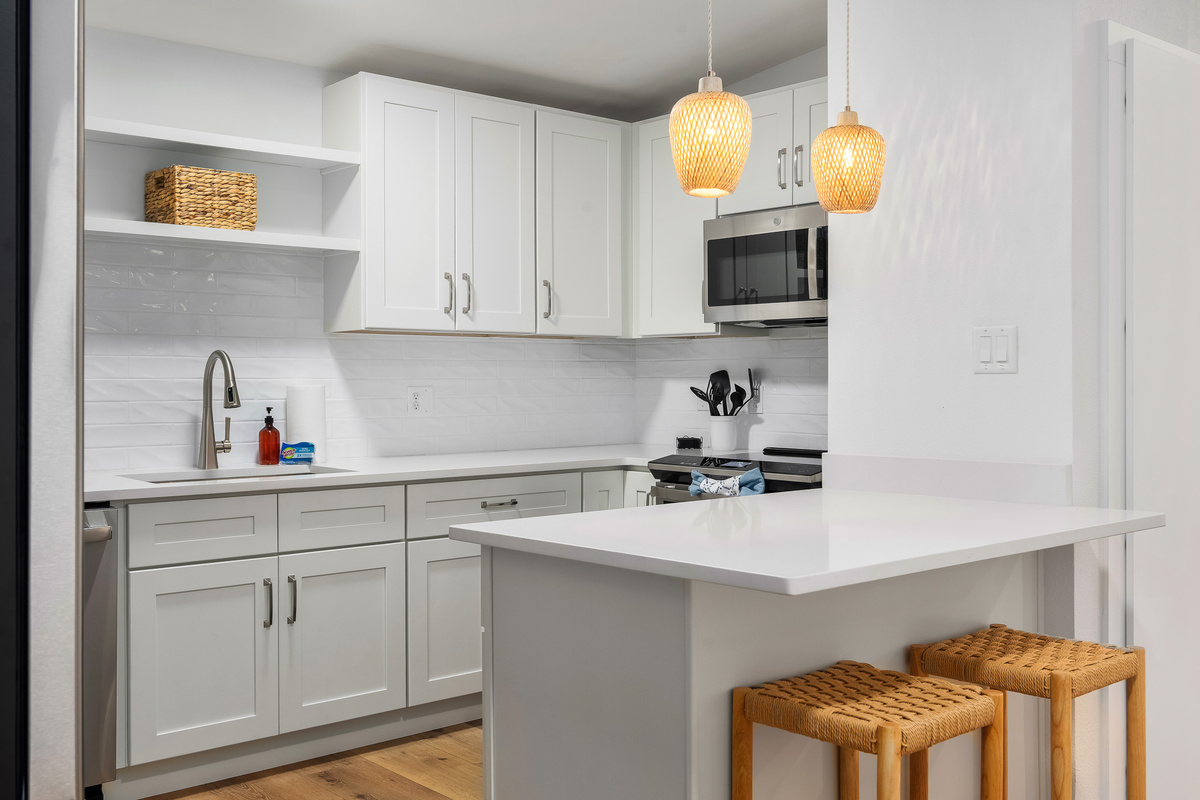 Fully stocked kitchen with new GE stainless steel appliances, a large refrigerator, a modern oven with built-in air fryer, and a deep sink with a retractable faucet— perfect for preparing home-cooked meals!