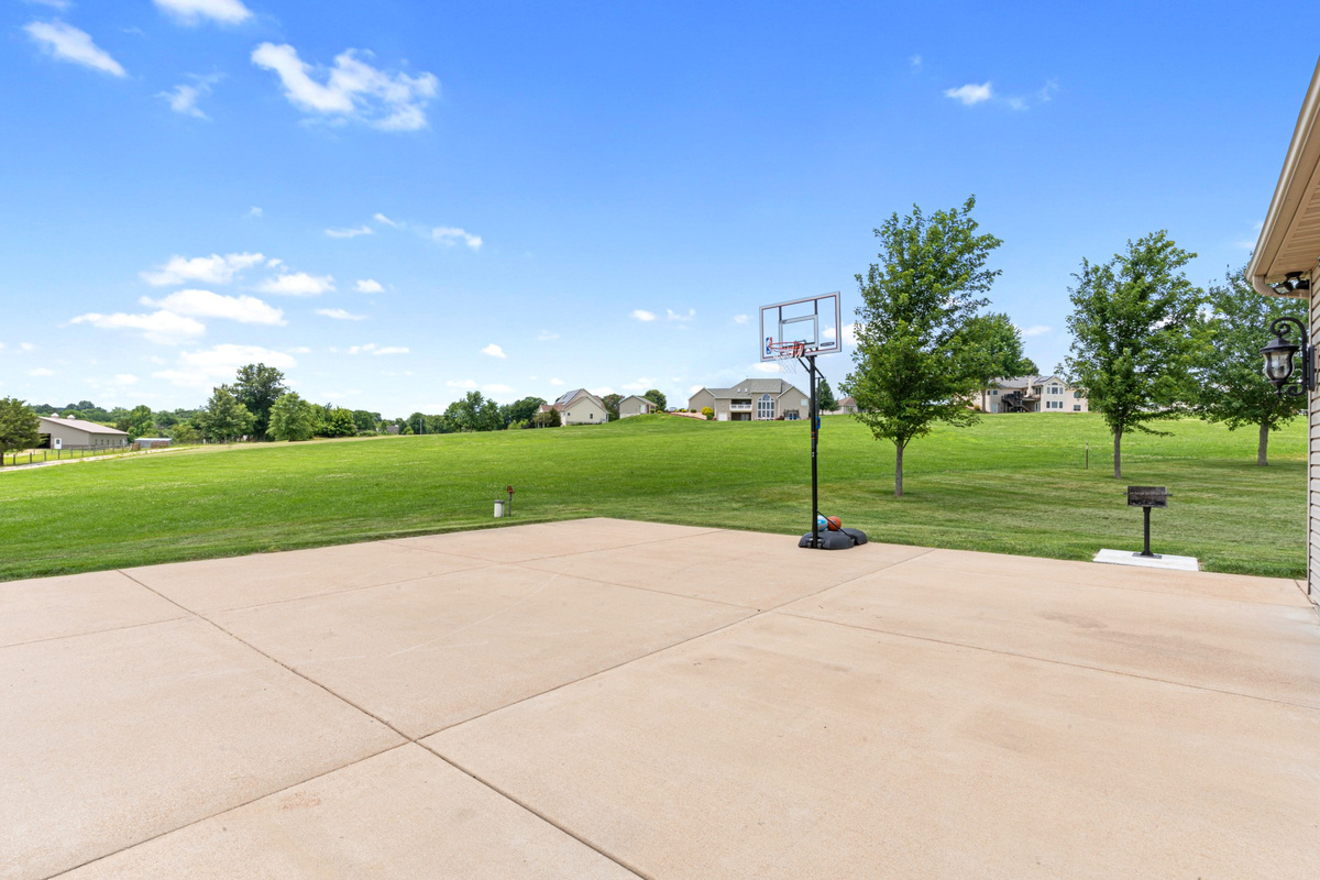 Large driveway with a full-size basketball hoop for fun with kids, teens, and adults.