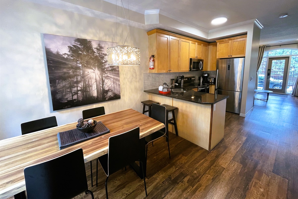 View from the kitchen/dining towards the living room.  Second entry, facing the patio visible in the background.