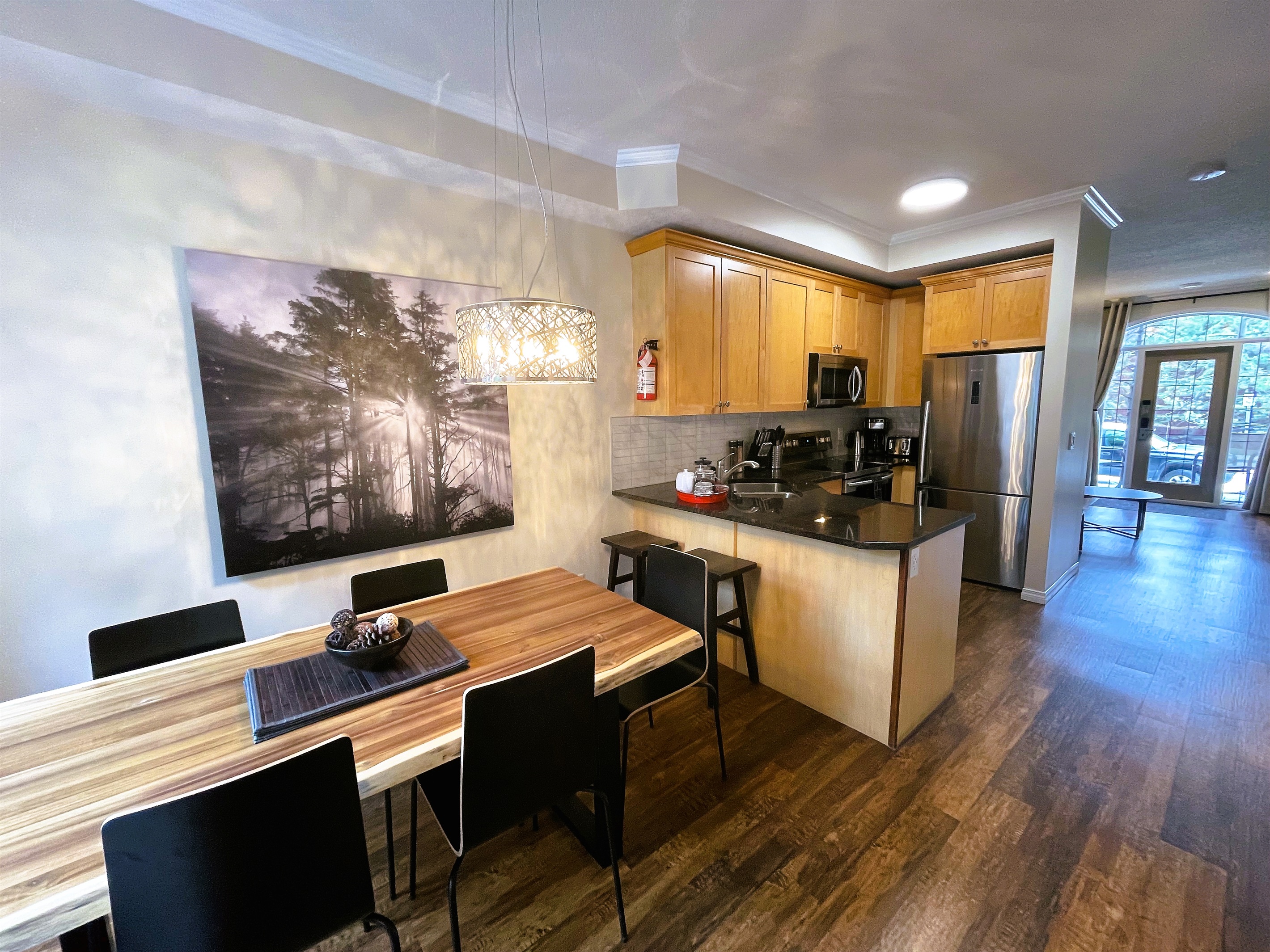 View from the kitchen/dining towards the living room.  Second entry, facing the patio visible in the background.