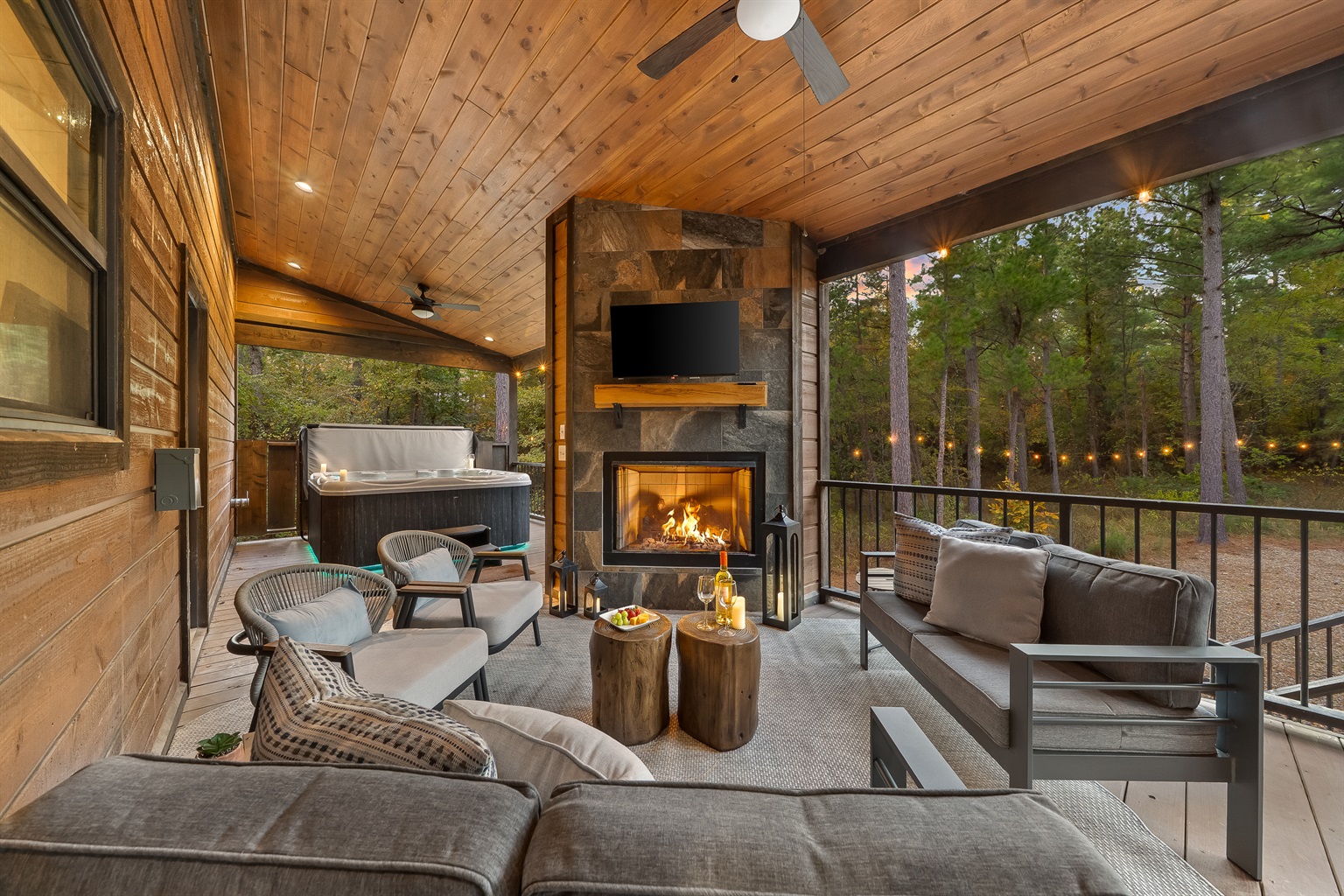 Outdoor living at its finest. Cozy seating, a glowing fireplace, and a hot tub only steps away set the scene for unforgettable nights.
