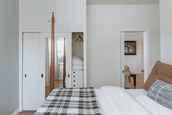 Original built-ins and a hidden compartment in the closet add to the delightful details around every corner. This room also has a pock door leading to the living room.