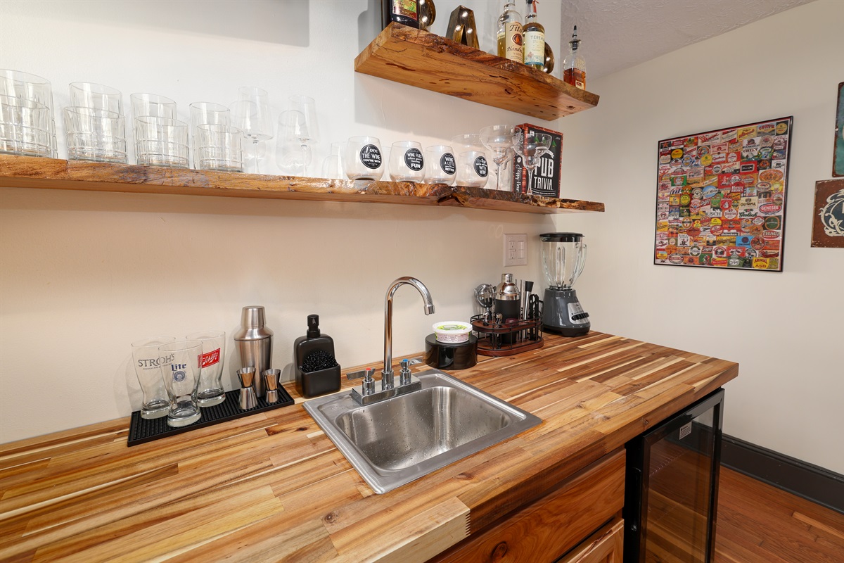 Full Bar with seating, ice machine, sink, refrigerator, bar ware, glasses