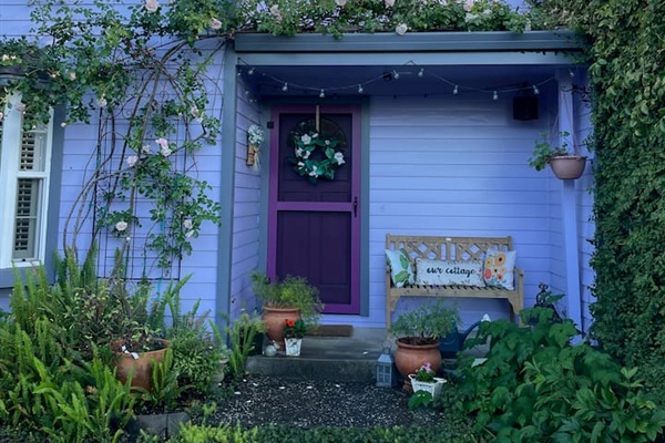 Enjoy the peaceful patio and charming front yard, with greenery, flowers, and cozy outdoor seating for relaxing moments throughout your stay.