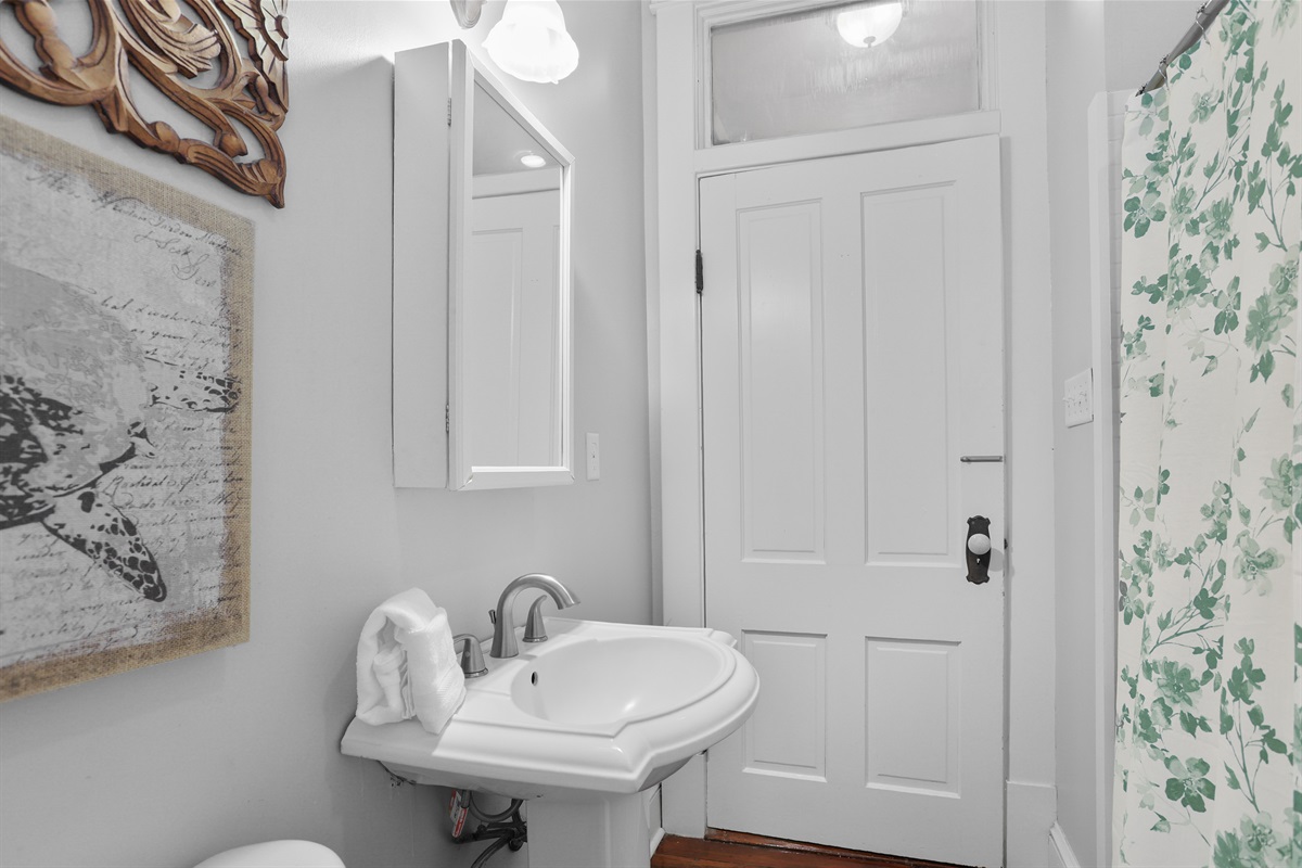 Simple, stylish bathroom that is stocked with the essentials for your stay.