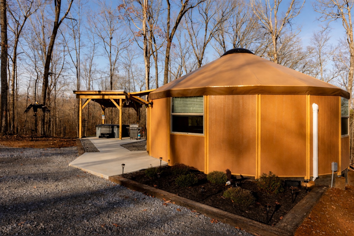 Eagle Retreat is a private, secluded yurt tucked into the forest, offering a peaceful escape with its own hot tub pavilion, outdoor lounge, and romantic evening lighting