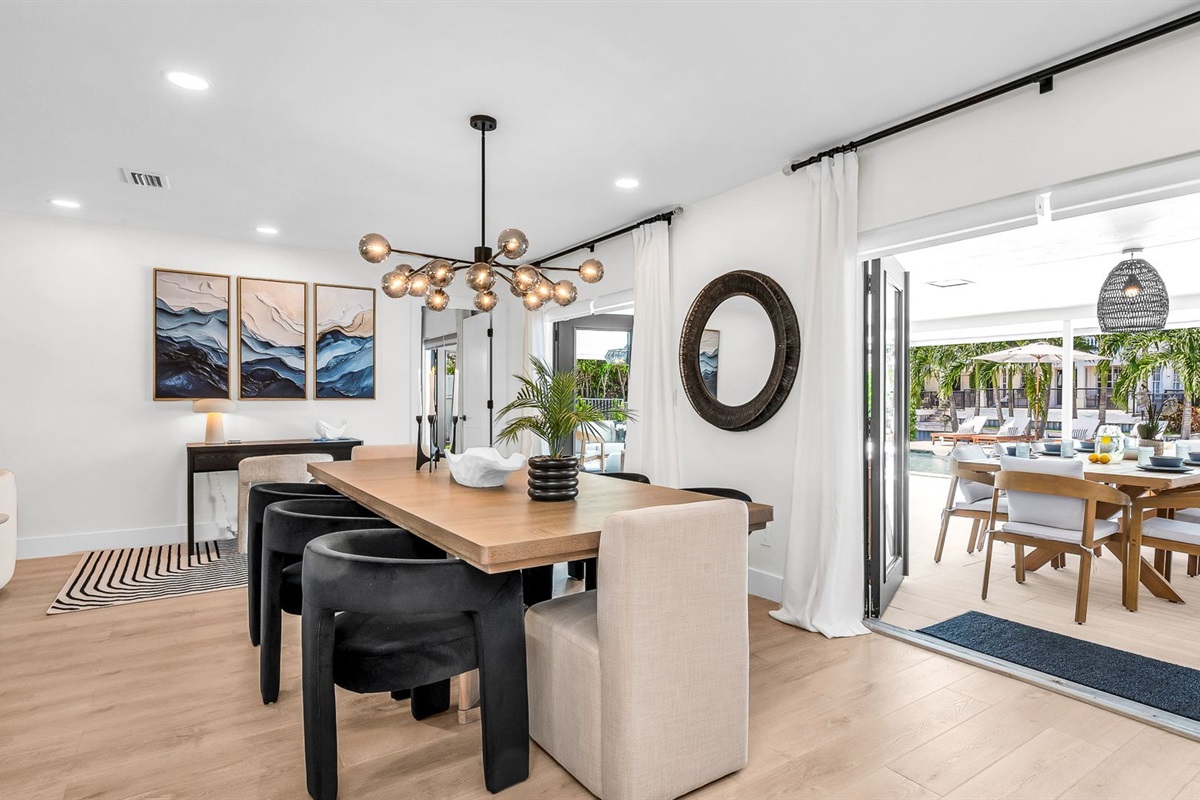 Experience resort-style dining with a designer table for 8 indoors and al fresco seating for 10 by the pool, offering an elegant backdrop for unforgettable gatherings