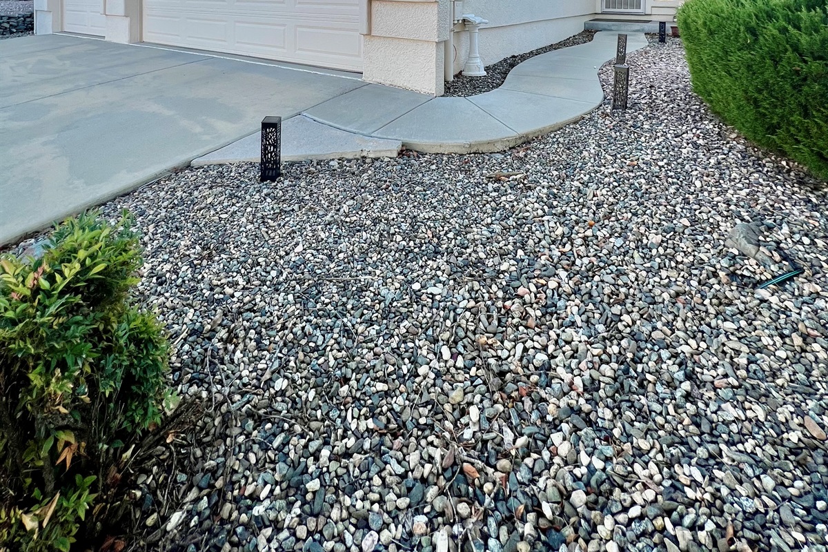 The exterior of the home exudes a sense of welcome and belonging. The well-lit driveway and garage entrance provide a convenient and safe arrival experience