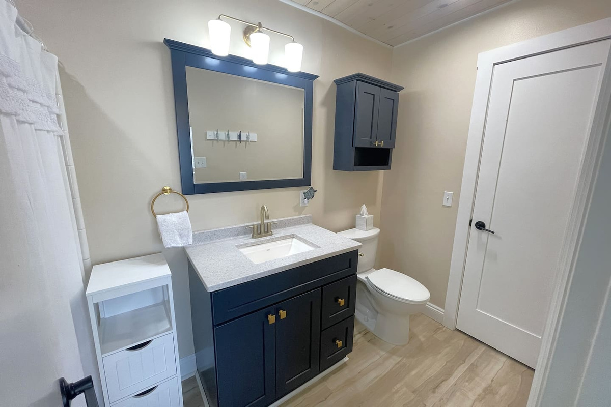 Your guest bathroom handles the whole group &mdash; full shower, tub, storage, and space to actually get ready without bumping into each other.
