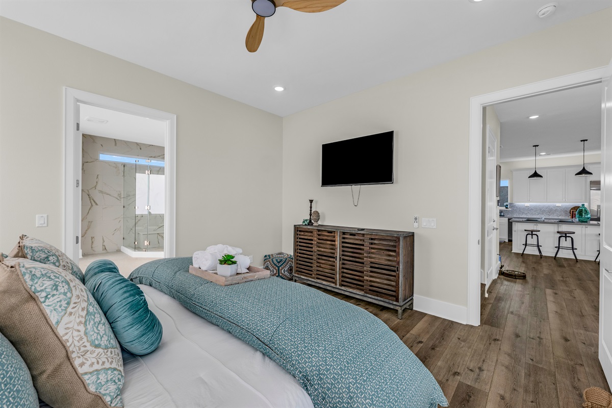 Costa Cristal Primary Ensuite: First-floor primary bedroom with a king-size bed and mounted TV for relaxing entertainment.