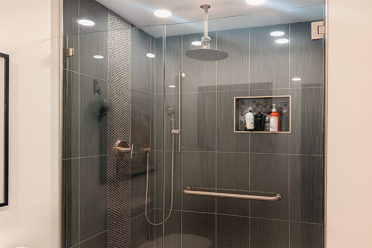 Full shared bathroom with spacious walk-in shower and modern tile, used only by guests in The Gold Room and the on-site hosts at Garden of Manors.