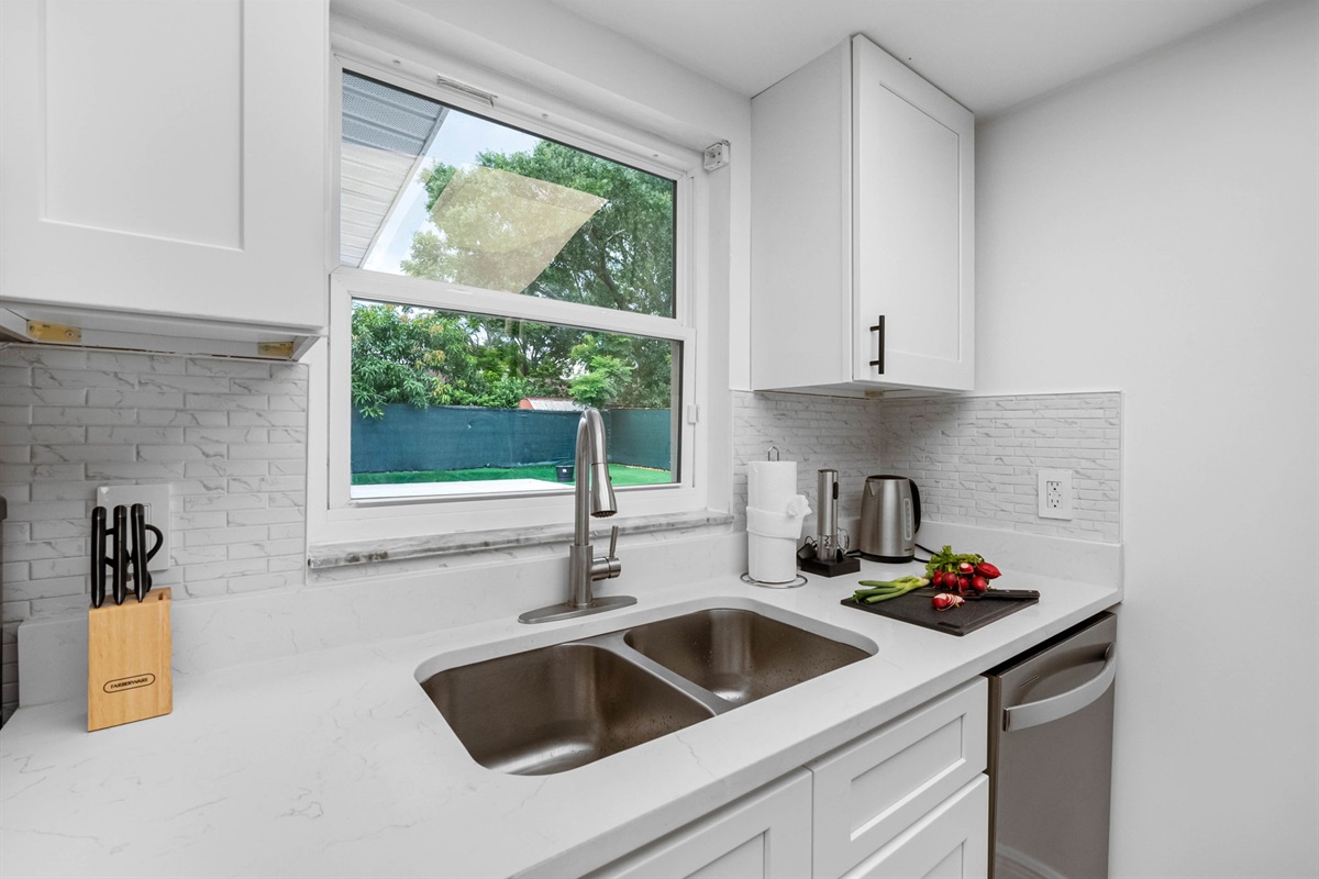 Thoughtful touches like soft-close drawers and under-cabinet lighting elevate the cooking experience.