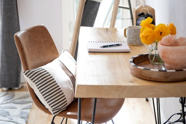 This inviting king bedroom features a dedicated desk and chair—perfect for catching up on work while enjoying natural light and beautiful mountain views. Step out onto the private balcony for a peaceful break between meetings or adventures.