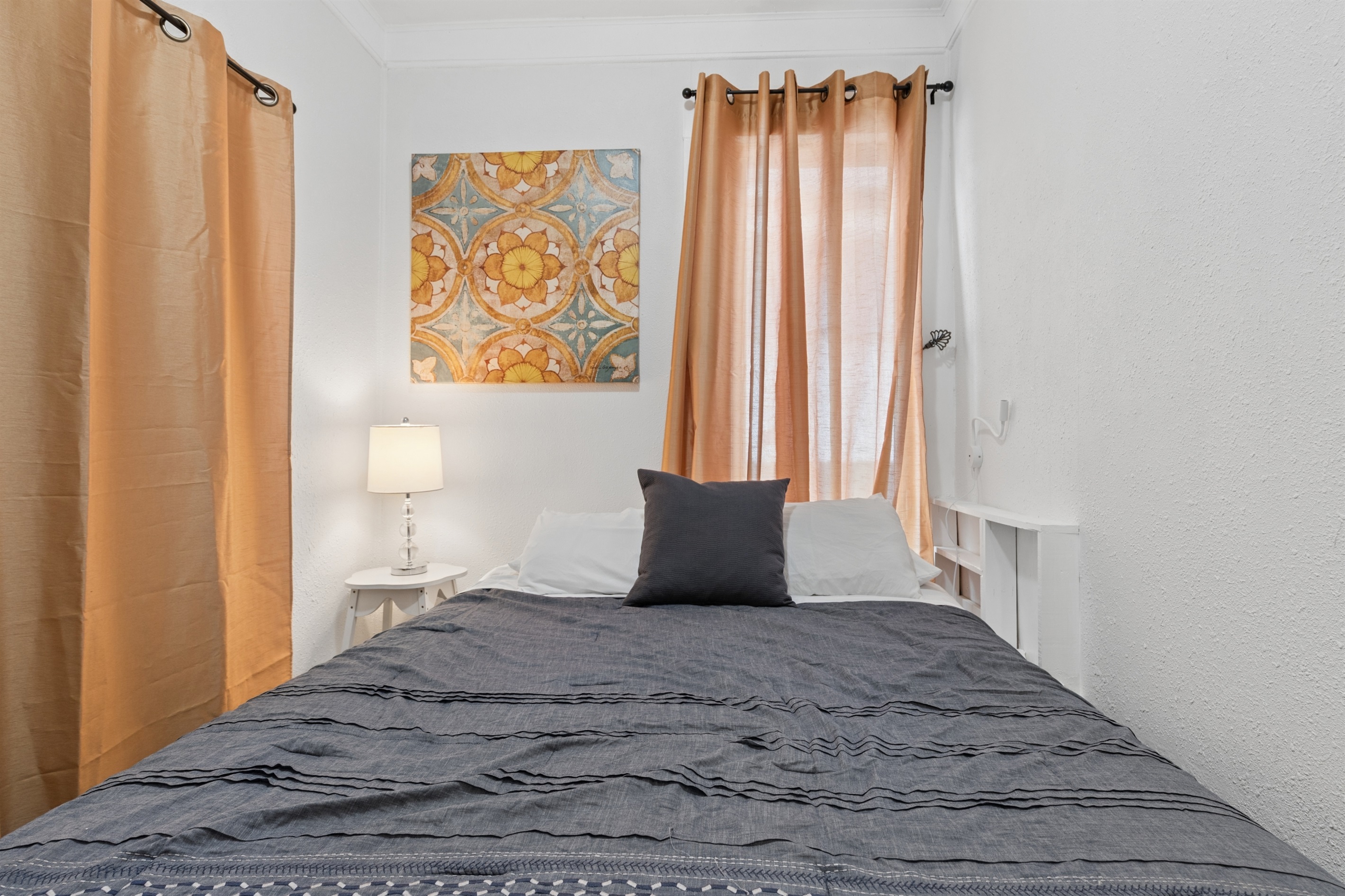 The first floor queen bedroom is cozy and comfortable.