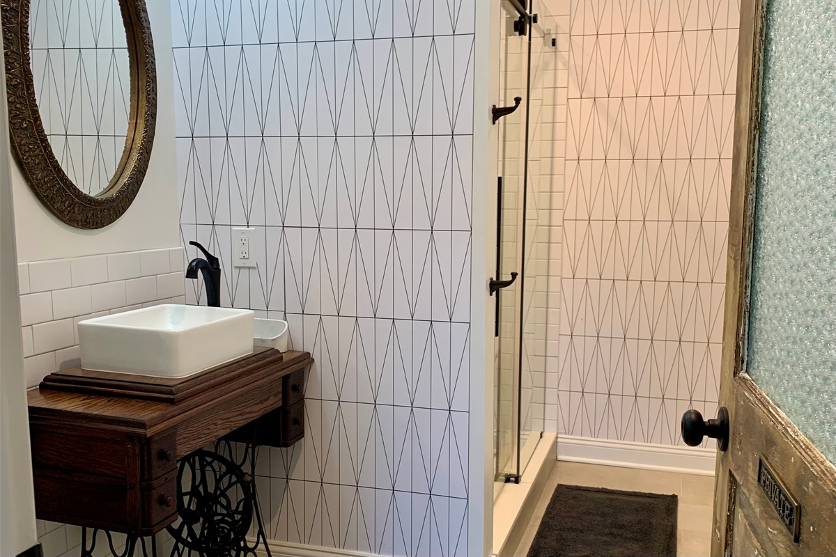 Vintage elements like this sink add a ton of character to the house. Big walk in shower with glass doors in this ensuite