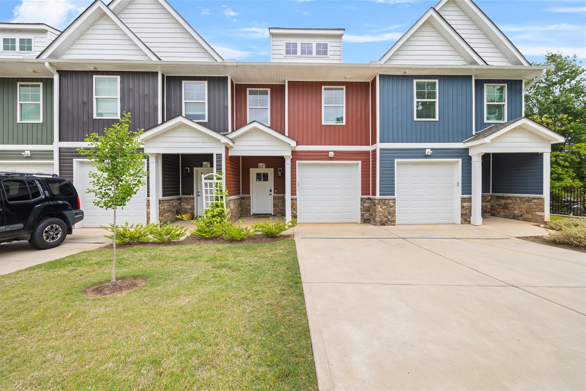 Perfectly framed between neighboring homes, the bright red façade creates a modern yet cozy feel in this well-maintained townhome community.