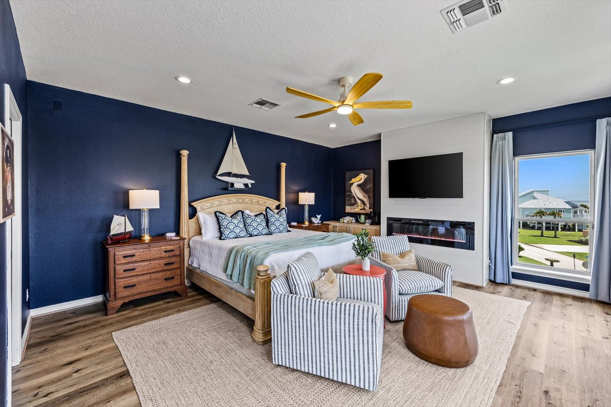 The Seafarer Primary Suite bedroom offers smart TV, electric fireplace for ambiance, seating for relaxation and your private full bathroom. This bedroom along with the coffee and tea bar, has its own deck access for watching the sunrise, mug in hand.
