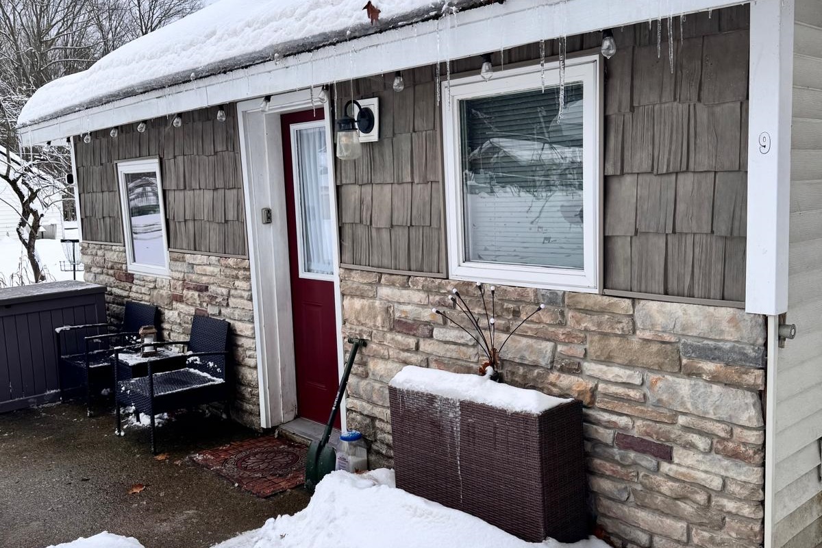 Step into your winter escape through this serene, snow dusted front entrance