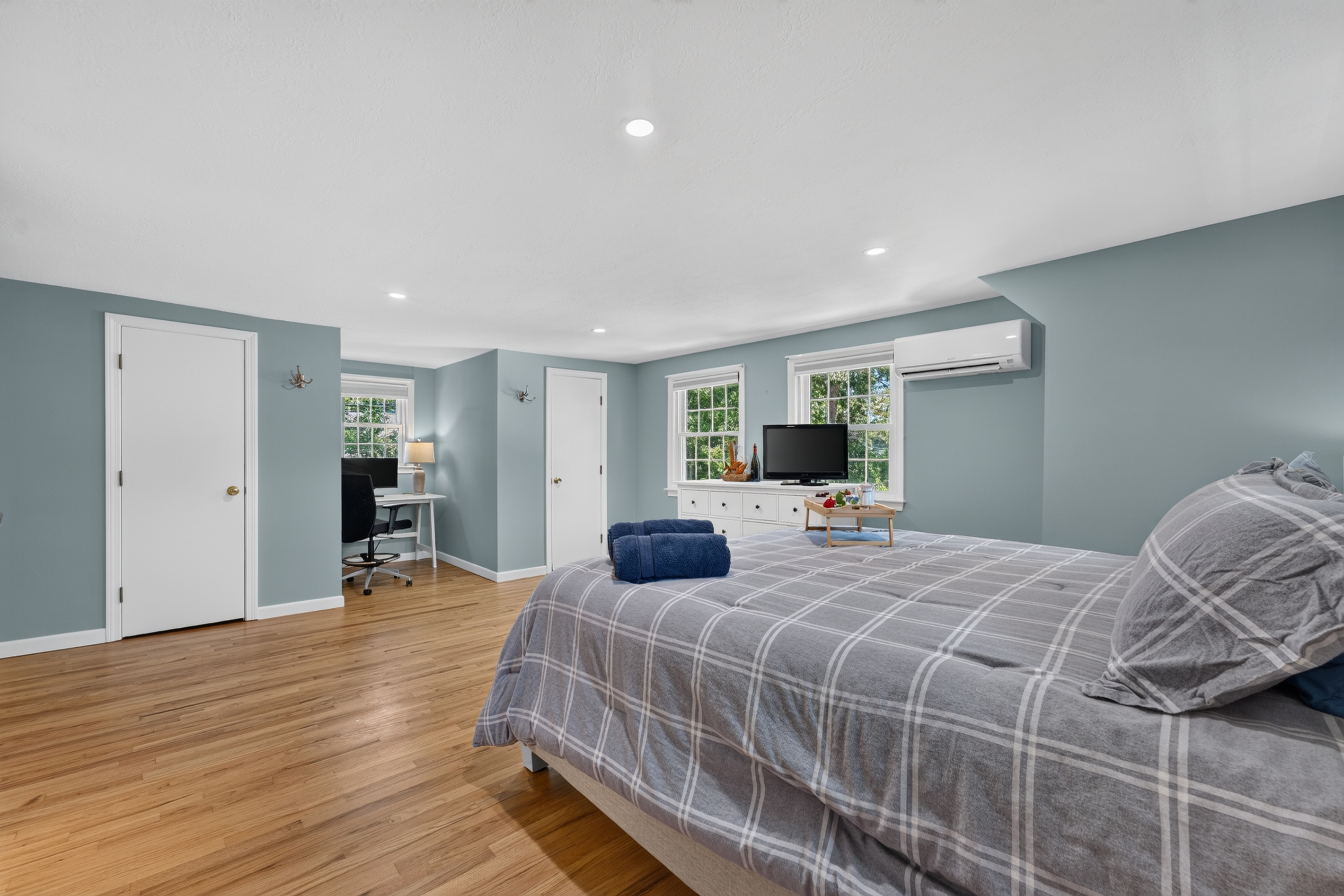 Large primary bedroom designed with comfort and simplicity in mind.
