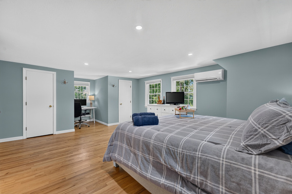 Large primary bedroom designed with comfort and simplicity in mind.